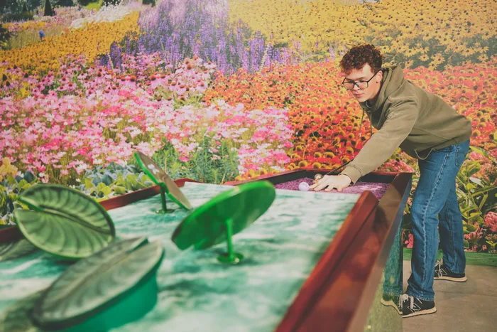 Charlie lining up a shot on the lily-pad hole