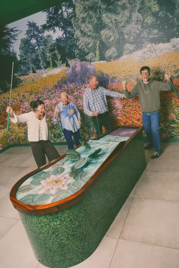 Friends cheering and celebrating round the lily-pad hole