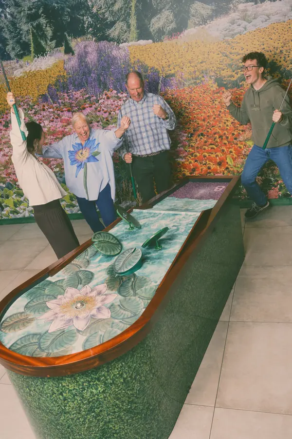 Four players celebrating on the lily-pad hole