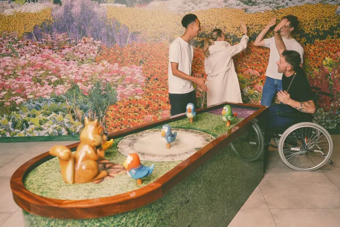 A group cheering a shot on the bird-bath hole