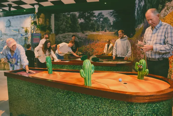 A family group playing the cactus hole
