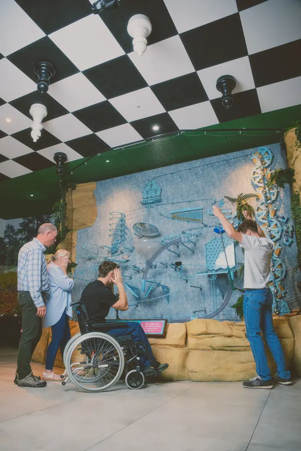 A group celebrating under the checkerboard ceiling