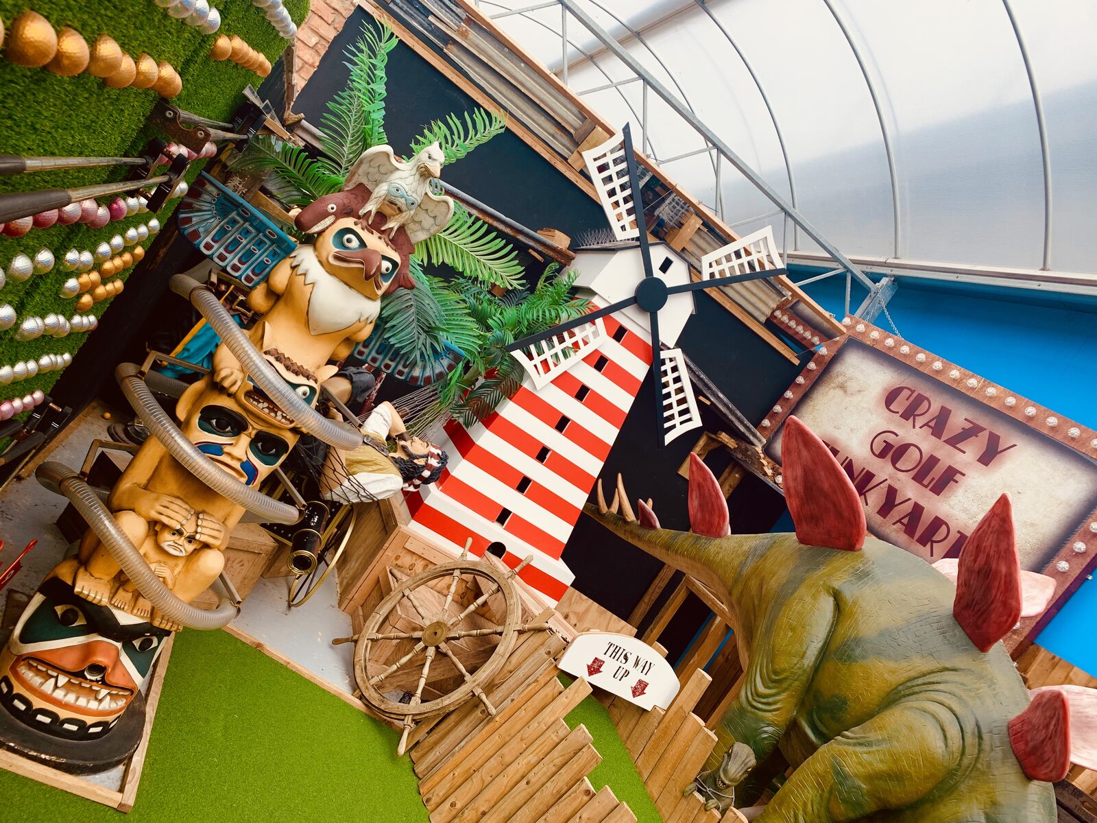 Themed Adventure Golf course at Flower Bowl — windmill, pirate galleon and crazy golf signage